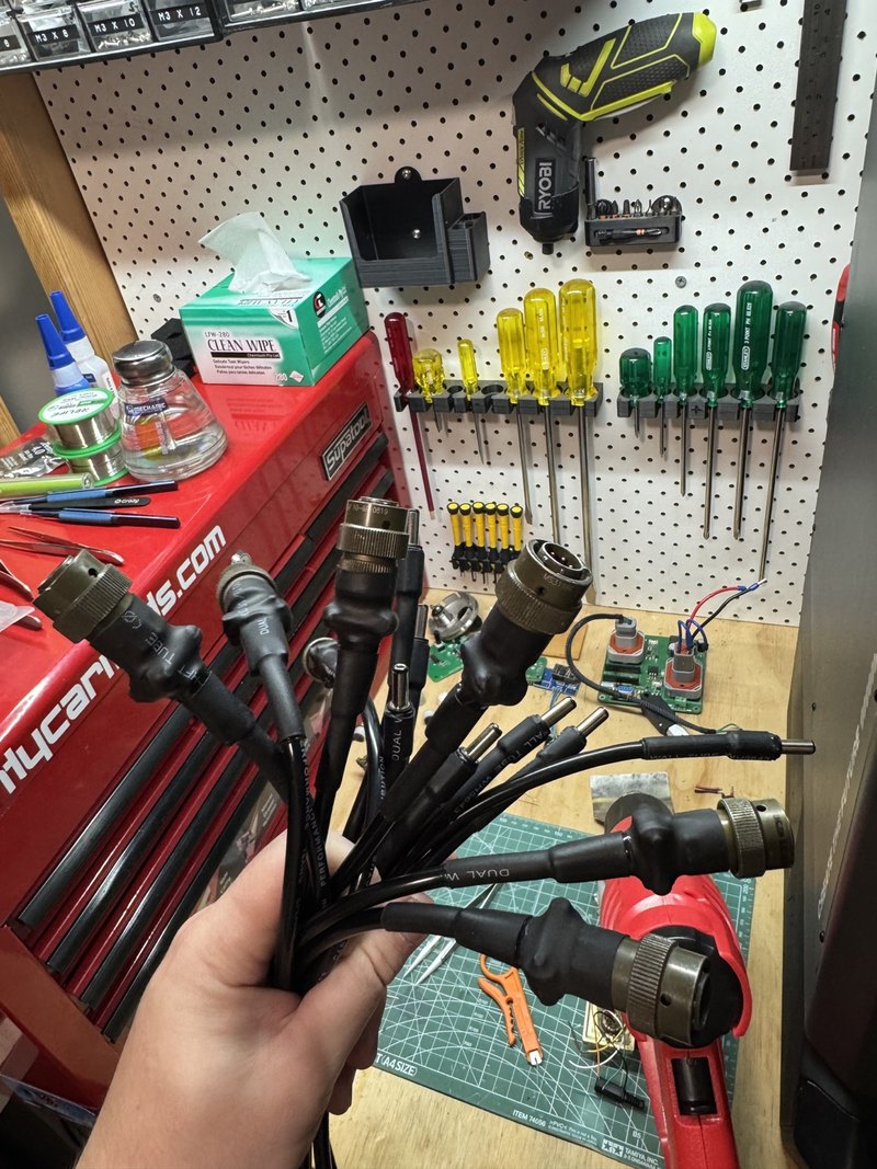 Completed short-run connector harnesses on a workshop bench